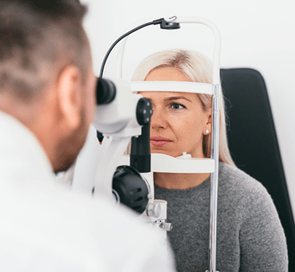 Eye doctor giving comprehensive eye exam to patient in Iowa at one hour optical