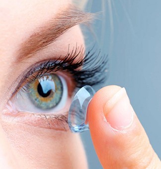 Woman putting in her new contact lenses